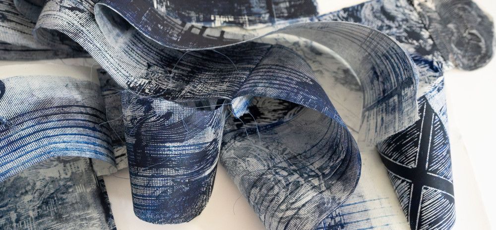 Printed reels holding inked reproductions from linocuts.