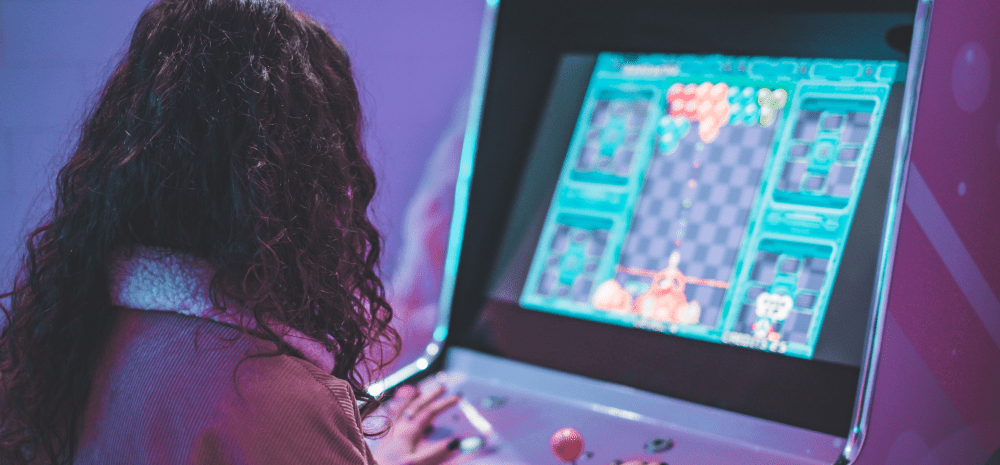 Person playing a video arcade game.