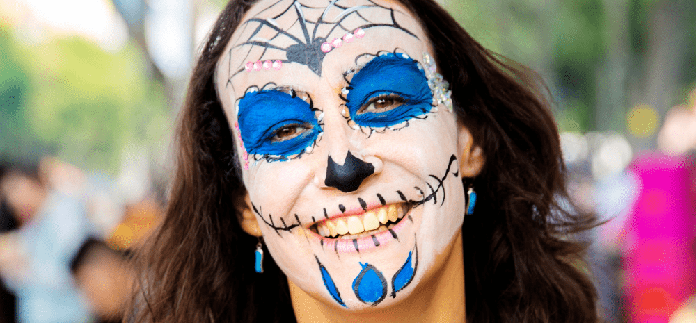 A woman with spiderweb facepainting on. 
