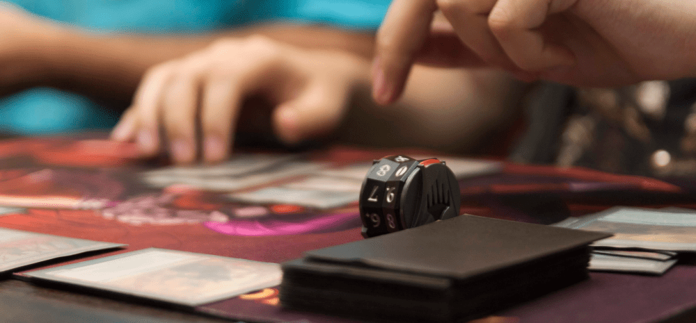Closeup of hands and a board game.