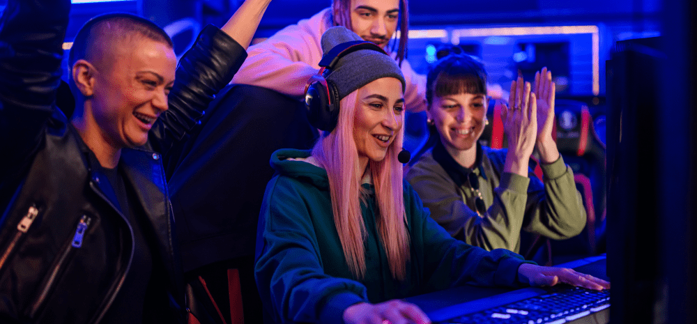 Several people wearing headsets and enjoying live gaming at computer station. 