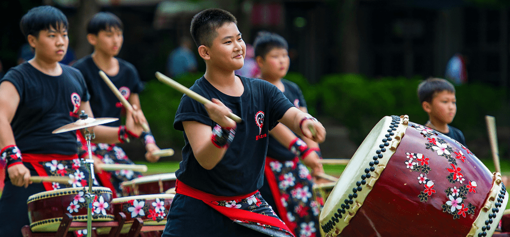 Five boys playing Taiko drums. 