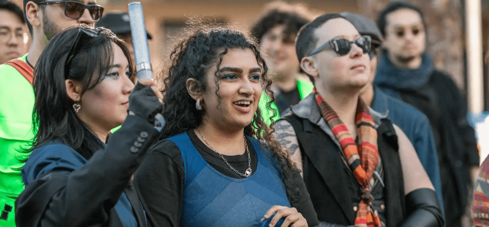 Group of people outdoors at an event in an urban environment.