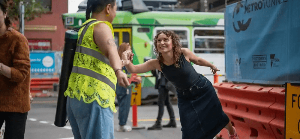 Two people locking hands in an urban environment.
