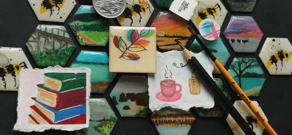 A display of small mixed media artworks - miniature paintings, drawings and collages.