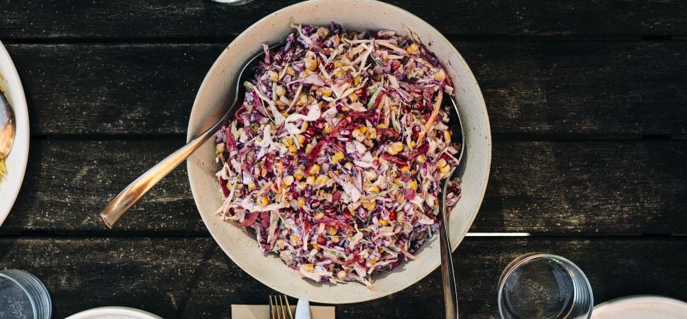 A bowl of colourful pomegranate salad on the table.