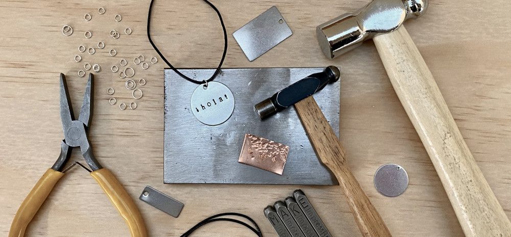 Metal working tools displayed on a wooden table.