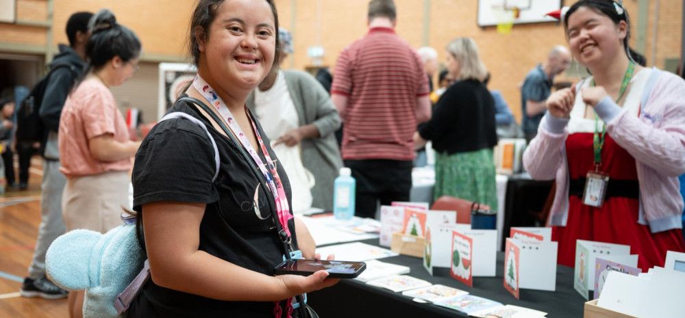 Disability pride stallholder and attendee.
