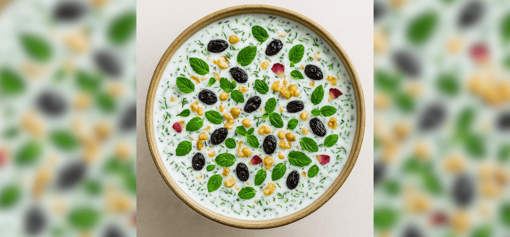 A bowl full of colourful Persian yoghurt soup with herbs and spices.