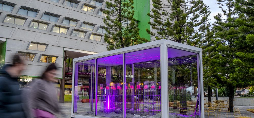Glass display box with the Dandenong Library andCivic Centre in the background.