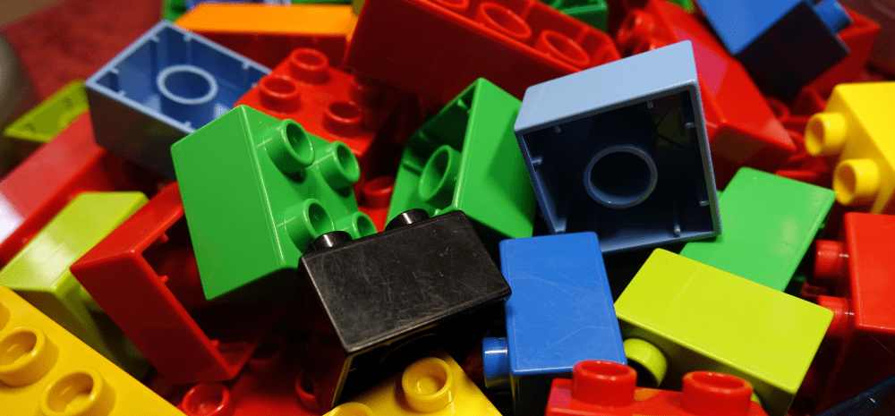 Colourful lego pieces that are broken up individually.
