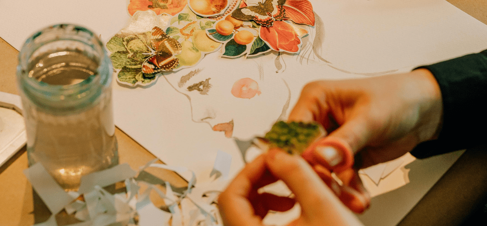 Hands creating a floral paper collage portrait.