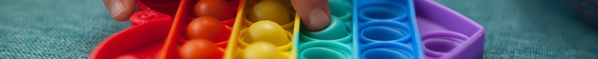 Heart shaped rainbow coloured sensory toy.