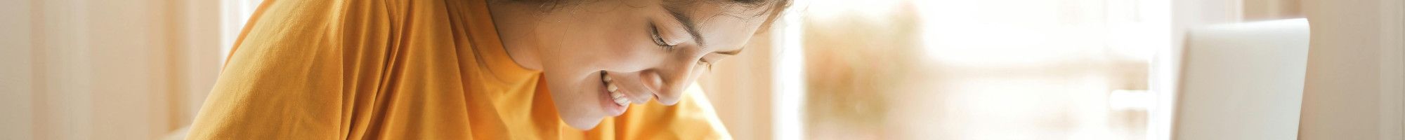 A girl sitting at a desk studying.