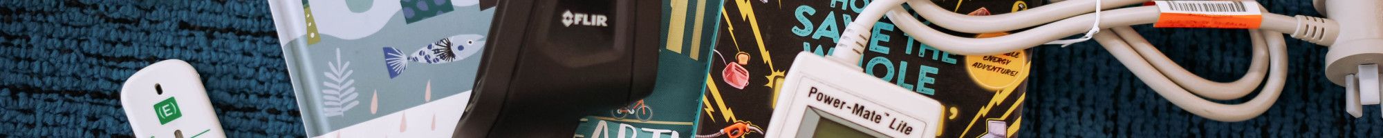 Books and various gadgets from library collection laid out on carpet.