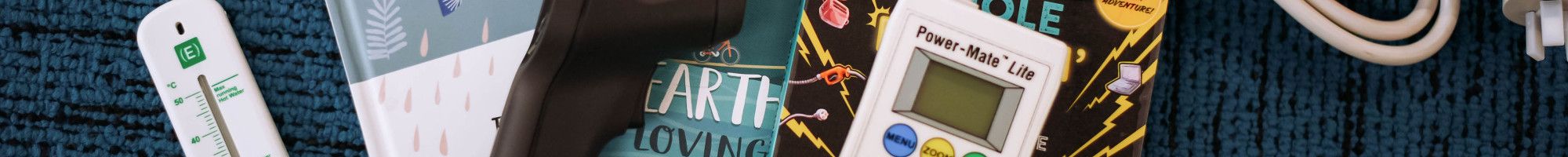 Thermometer, thermal imaging camera and Power Mate Lite devices arranged on library books.