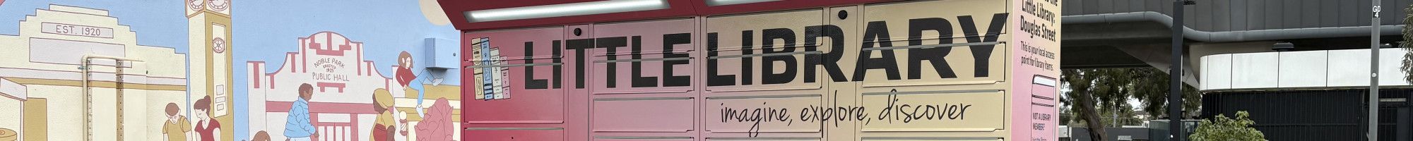 A set of brightly coloured lockers at Douglas Street, Noble Park with the words Little Library across the top.