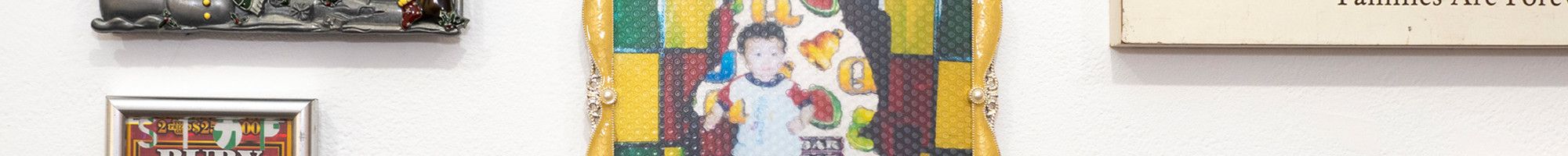 Differently styled photo frames hanging up on a white wall.