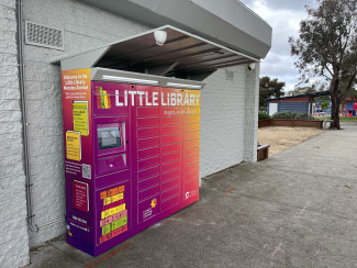 A set of brightly coloured lockers with the words Little Library across the top