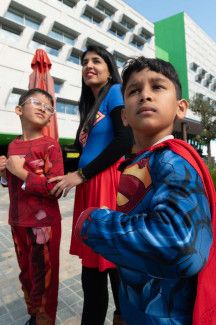 Three people in superhero costumes.