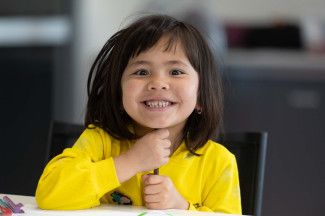 A child in a yellow shirt.