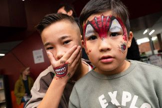 Two children with facepaint at Dandy-Con.