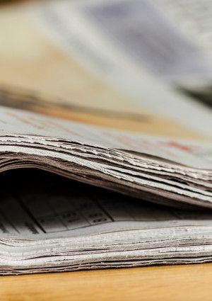 Newspaper folded on a table.