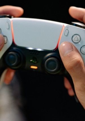 Games controller with hands on the controls.