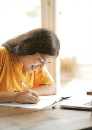 A girl sitting at a desk studying.