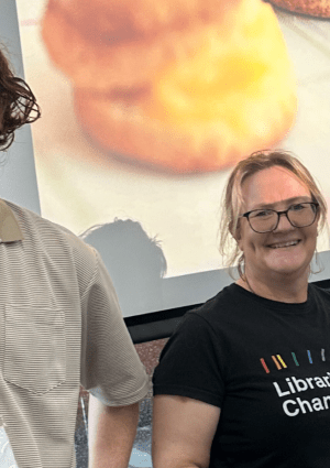 Staff members at Greater Dandenong Libraries standing in front of a screen.