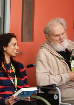 Staff member and library member talking in the library.
